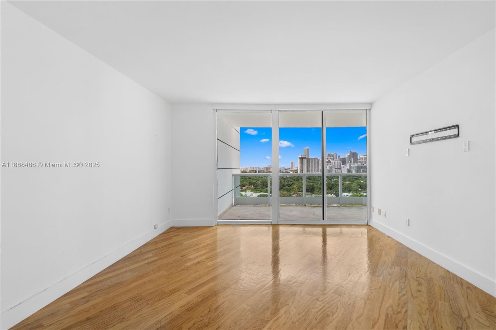 2127 Brickell Avenue, Unit 1504 Miami, FL 33129 - Photo 22 of 44 a view of a room with wooden floor and a window