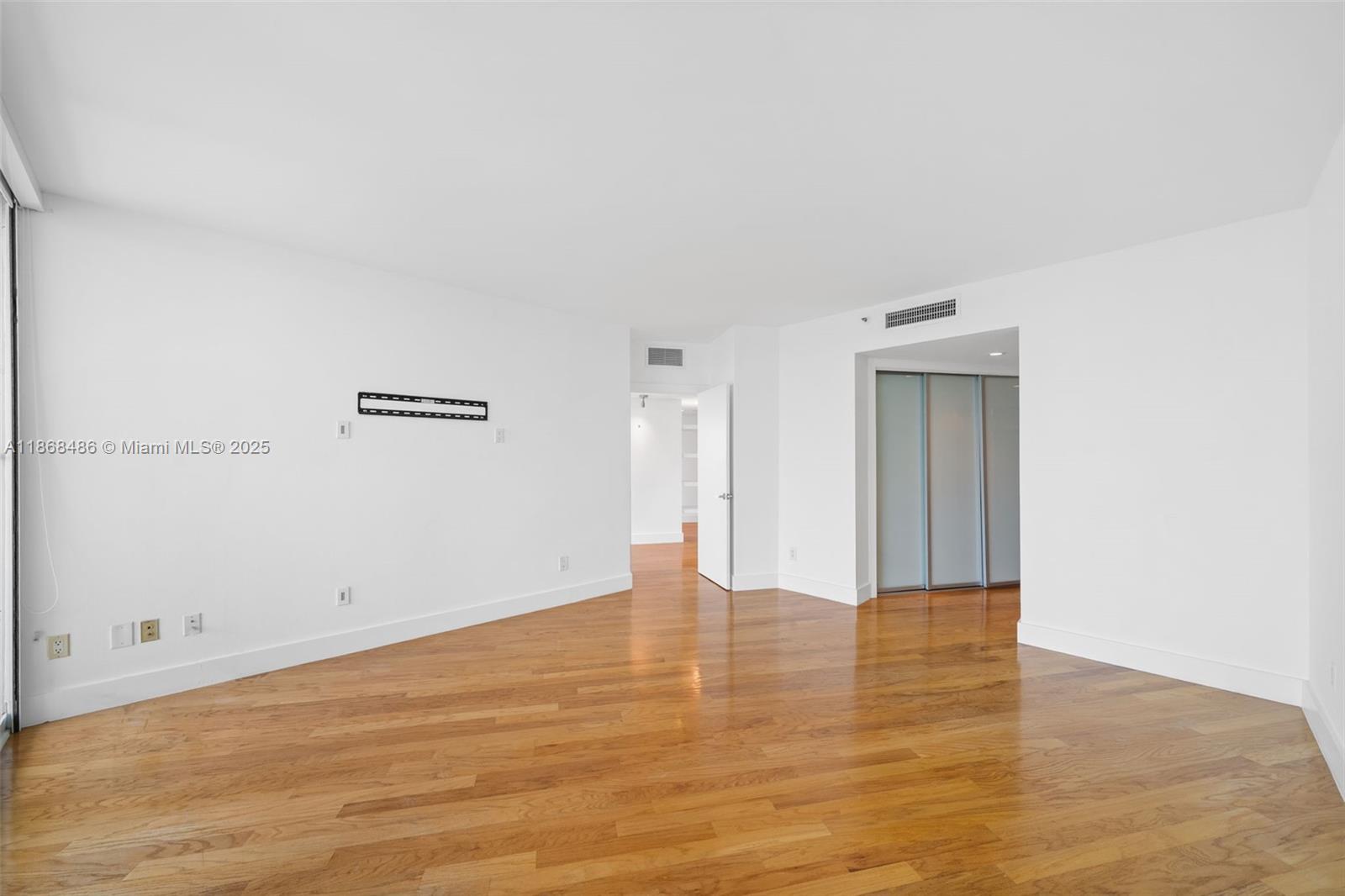2127 Brickell Avenue, Unit 1504 Miami, FL 33129 - Photo 23 of 44 a view of an empty room with wooden floor