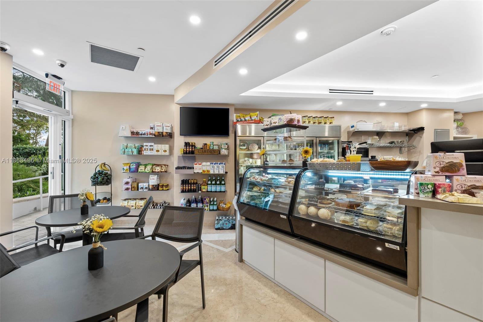 2127 Brickell Avenue, Unit 1504 Miami, FL 33129 - Photo 44 of 44 a room with stainless steel appliances lots of wooden furniture dining table and chairs