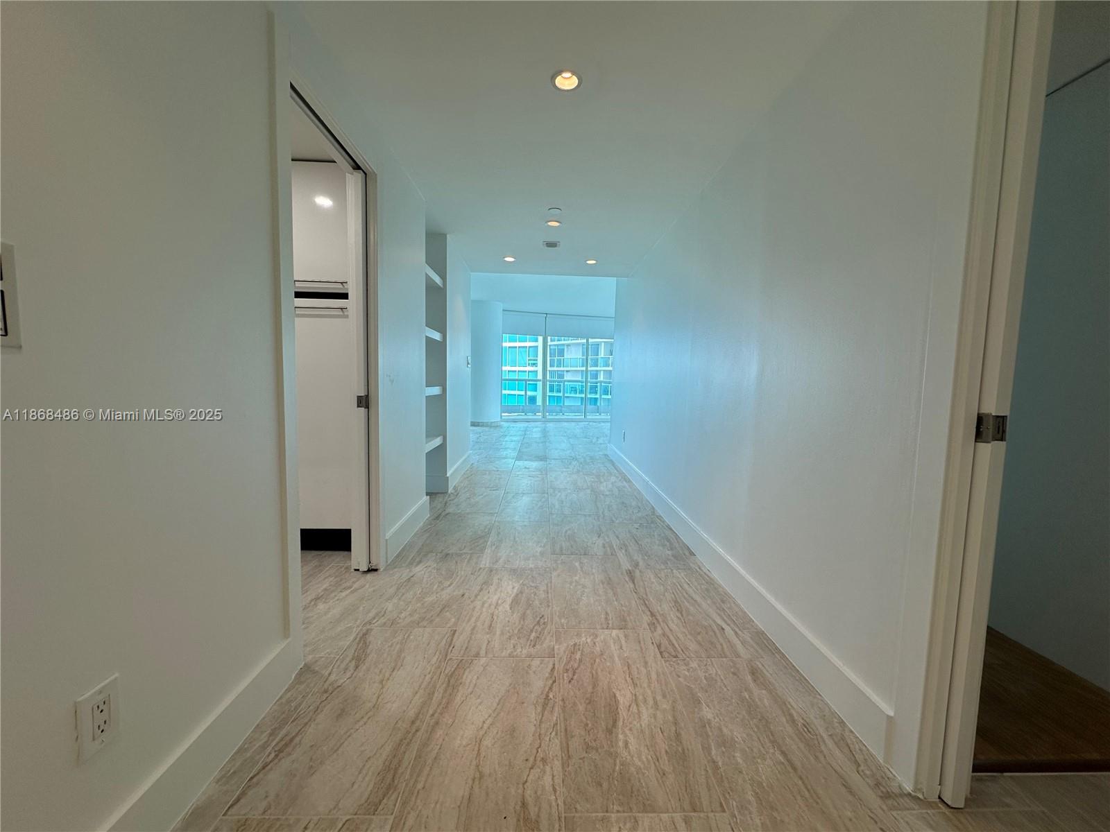 2127 Brickell Avenue, Unit 1504 Miami, FL 33129 - Photo 7 of 44 a view of a hallway with wooden floor and a bathroom