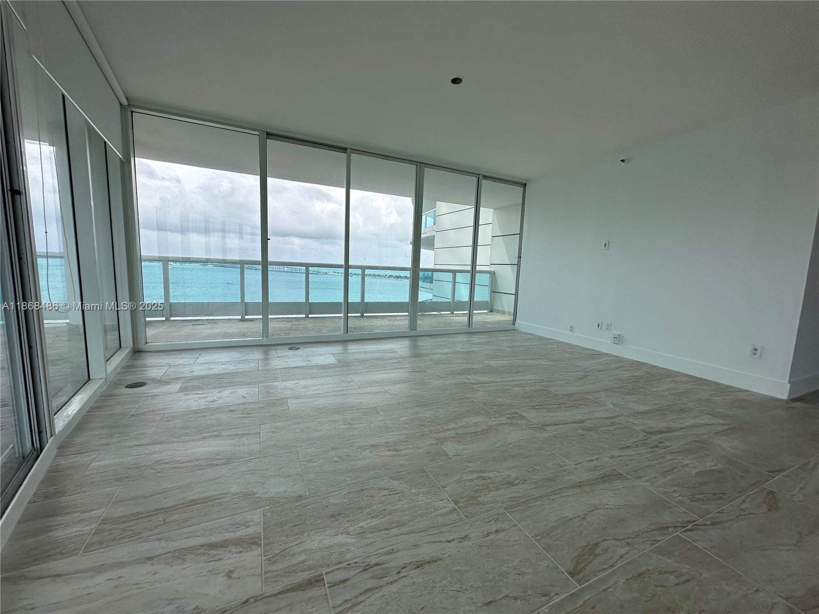 2127 Brickell Avenue, Unit 1504 Miami, FL 33129 - Photo 10 of 44 a view of an empty room with windows