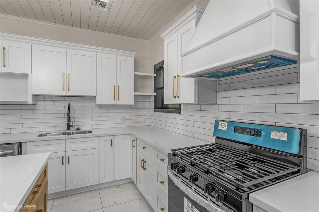 207 Red River Street Benton, LA 71006 - Photo 11 of 29 a kitchen with cabinets appliances and a stove