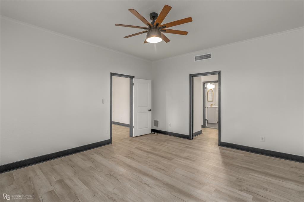 207 Red River Street Benton, LA 71006 - Photo 13 of 29 a view of an empty room with window and wooden floor