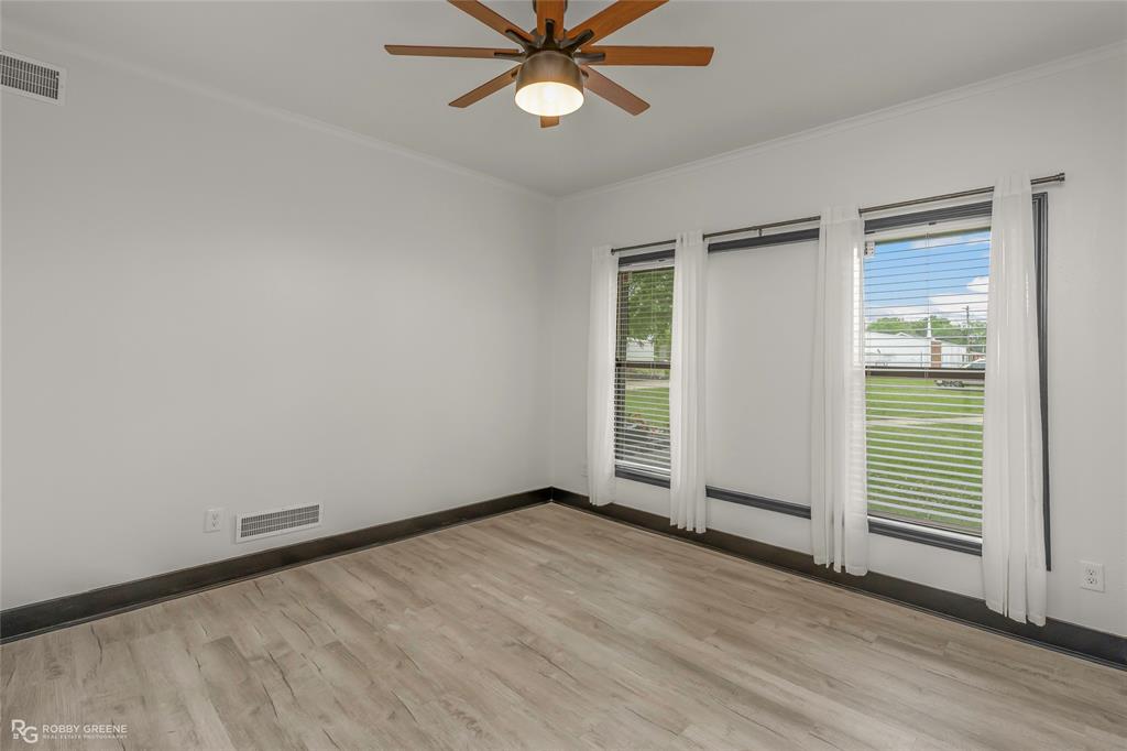 207 Red River Street Benton, LA 71006 - Photo 17 of 29 an empty room with wooden floor closet and windows