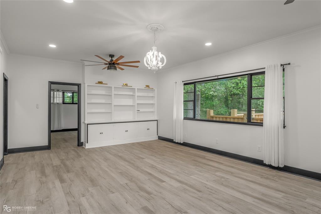 207 Red River Street Benton, LA 71006 - Photo 4 of 29 wooden floor in an empty room with a window
