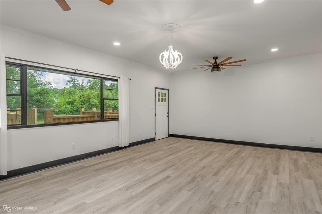 207 Red River Street Benton, LA 71006 - Photo 5 of 29 a view of empty room with wooden floor and fan