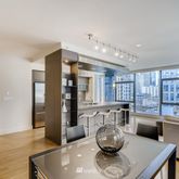 a kitchen with stainless steel appliances wooden floor and a refrigerator