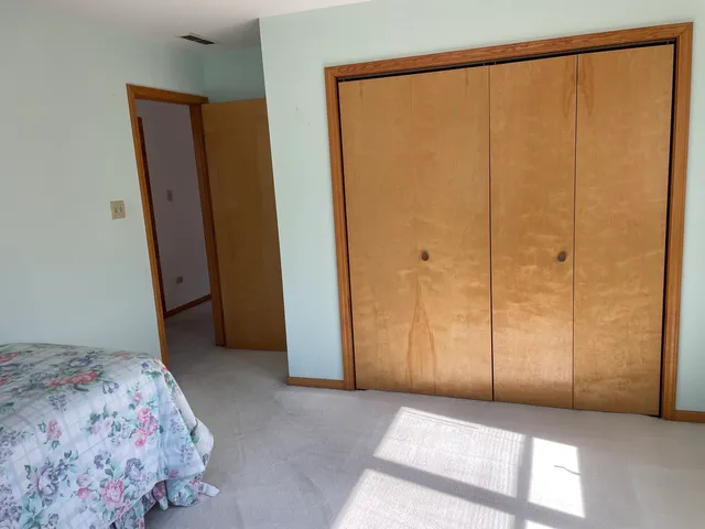 a bedroom with a bed and a dresser