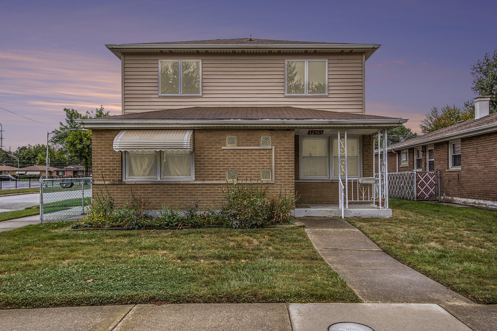 12901 South Muskegon Avenue Chicago, IL 60633 - Photo 24 of 25 a front view of a house with a yard