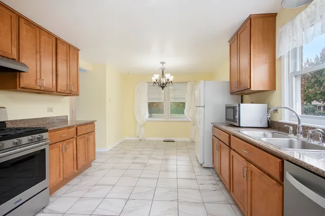 a kitchen with stainless steel appliances a sink stove and cabinets