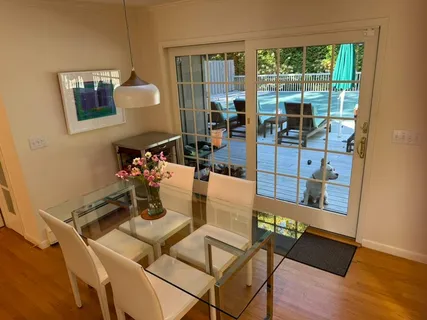 a view of a balcony with chairs and wooden floor
