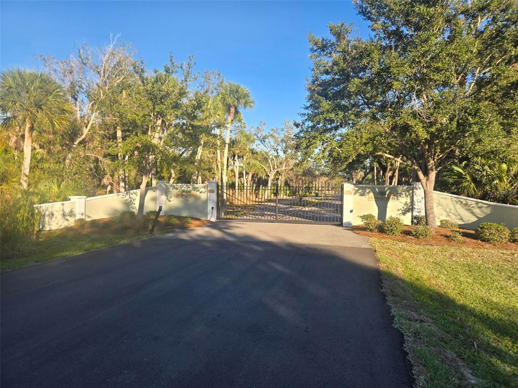9232 Spring Valley Road Englewood, FL 34224 - Photo 2 of 21 a view of road with large trees