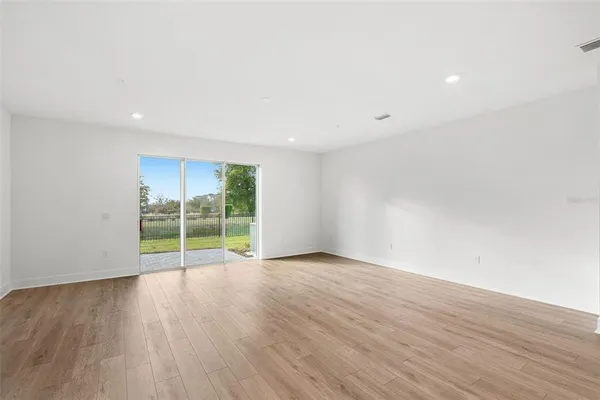 a view of kitchen with kitchen island and stainless steel appliances