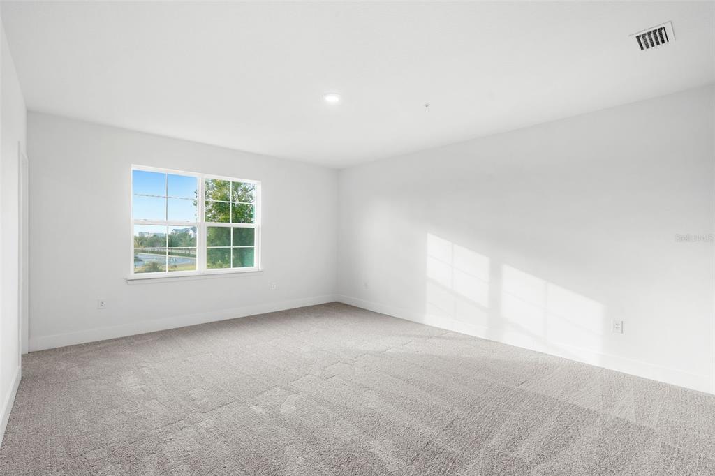 2438 Magnolia Reserve Road Ocoee, FL 34761 - Photo 22 of 26 an empty room with windows