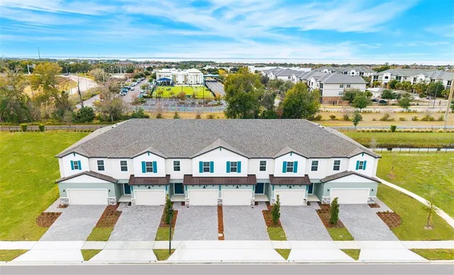 a view of residential houses with outdoor space and ocean view