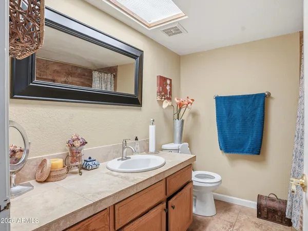 a white toilet sitting next to a shower curtain