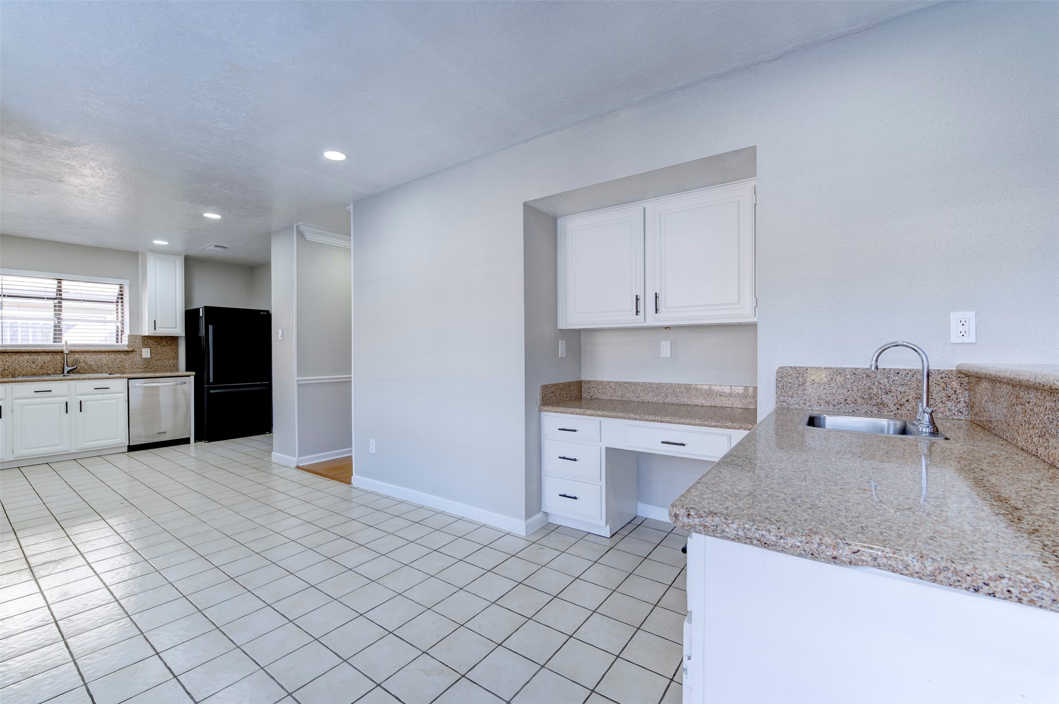 11434 High Bridge Court Houston, TX 77065 - Photo 15 of 31 a kitchen with granite countertop a sink stainless steel appliances and cabinets