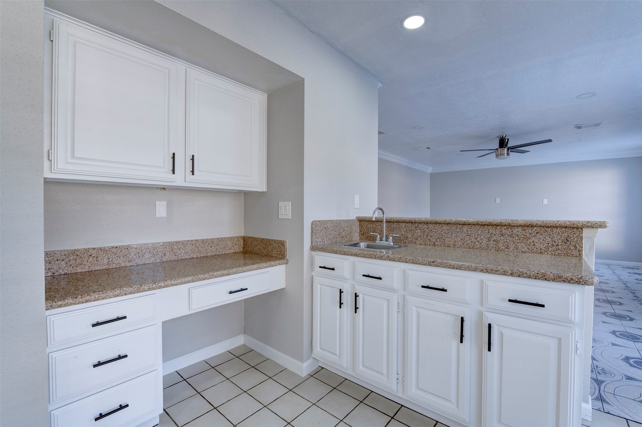 11434 High Bridge Court Houston, TX 77065 - Photo 17 of 31 a kitchen with granite countertop white cabinets and white appliances