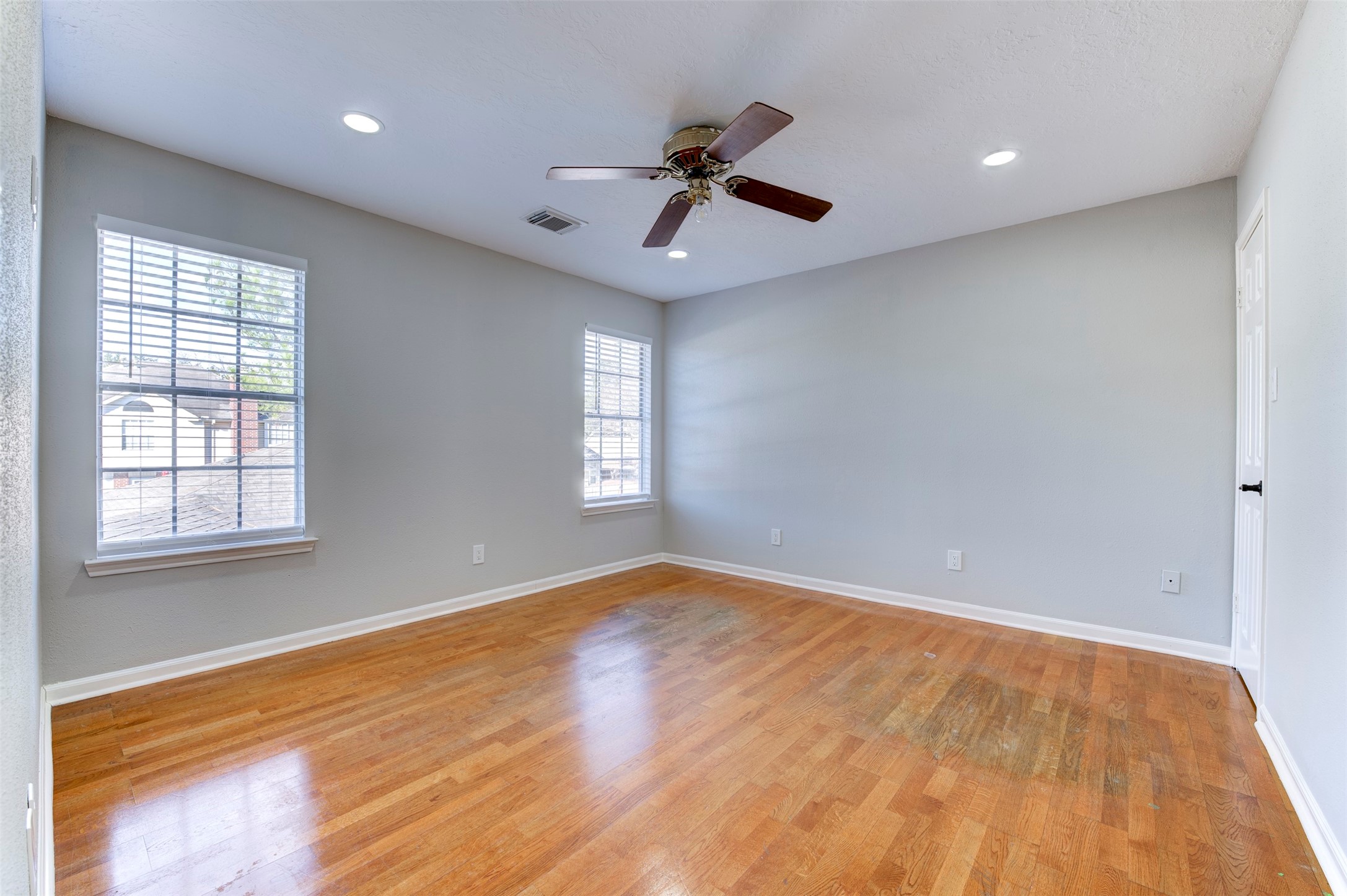 11434 High Bridge Court Houston, TX 77065 - Photo 21 of 31 a view of an empty room with wooden floor and a window