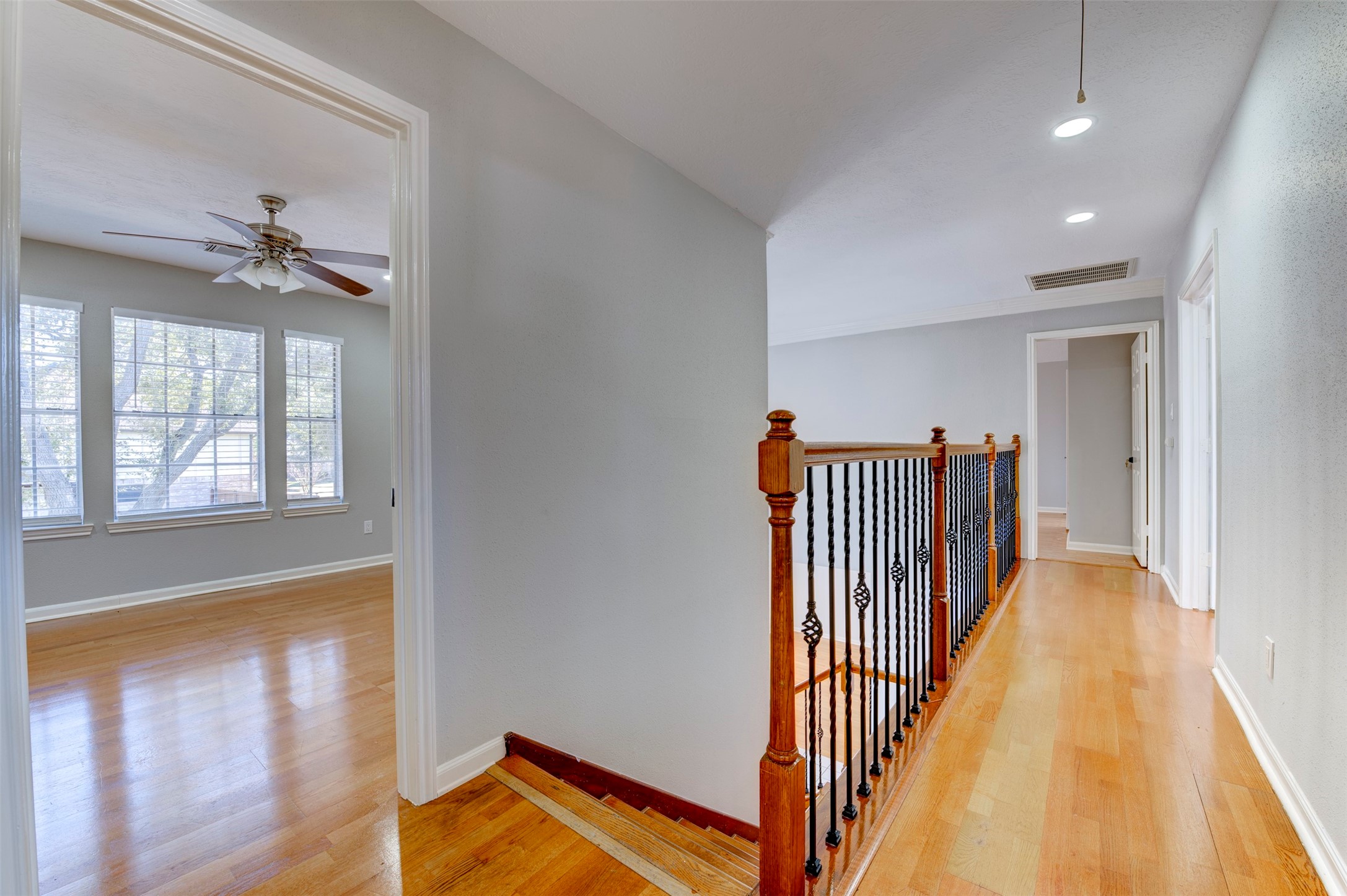 11434 High Bridge Court Houston, TX 77065 - Photo 23 of 31 a hallway with a large window and wooden floor