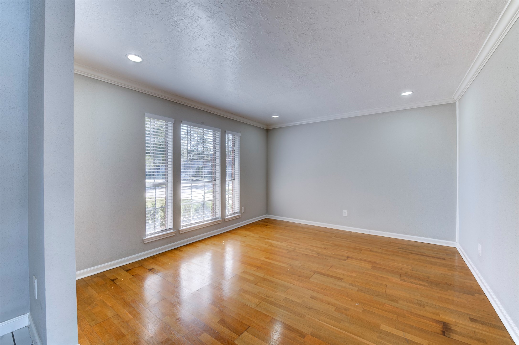 11434 High Bridge Court Houston, TX 77065 - Photo 5 of 31 a view of an empty room with wooden floor and a window