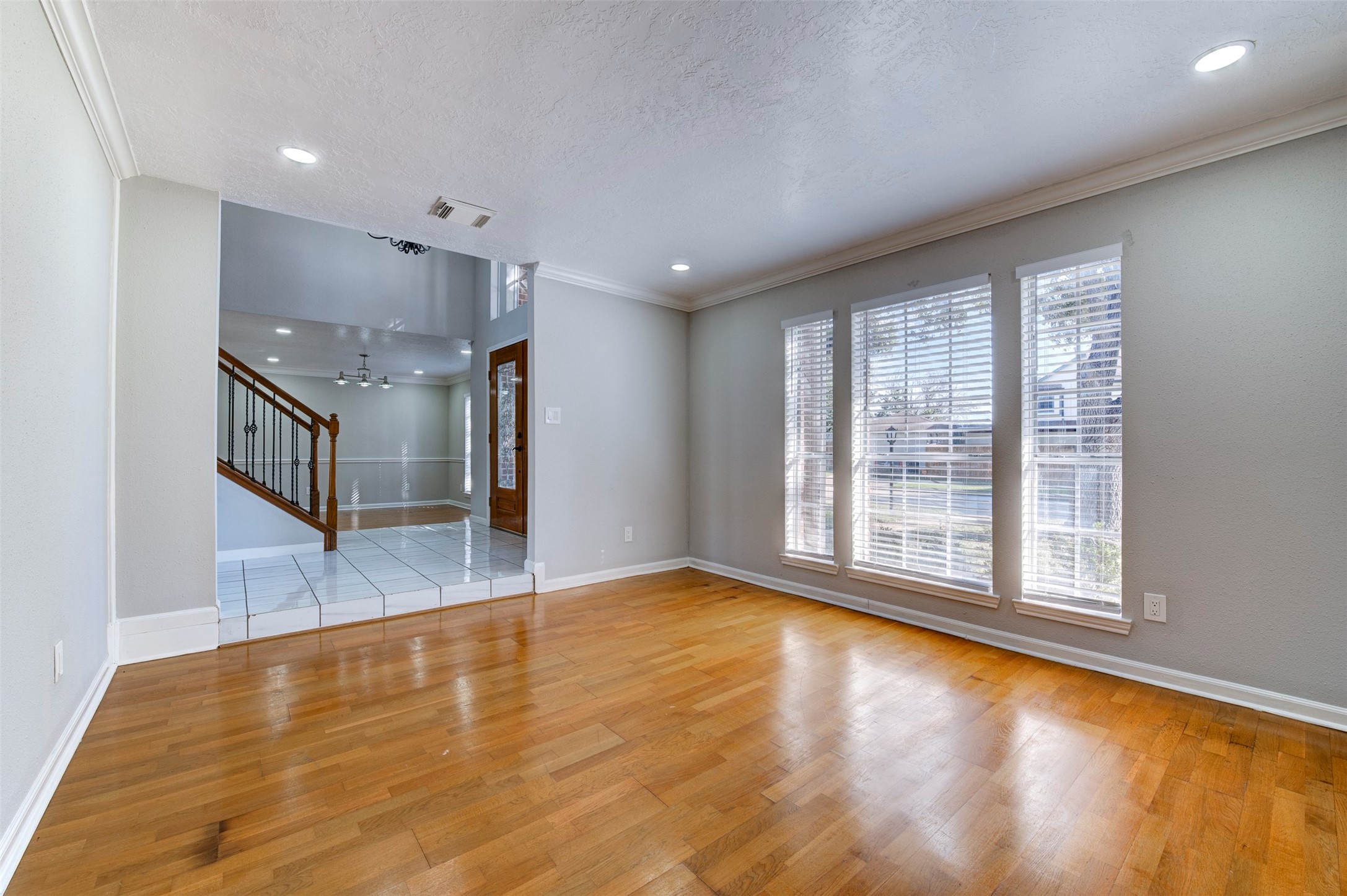 11434 High Bridge Court Houston, TX 77065 - Photo 6 of 31 a view of an empty room with window and wooden floor