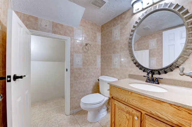 a kitchen with white cabinets a sink a window and stainless steel appliances