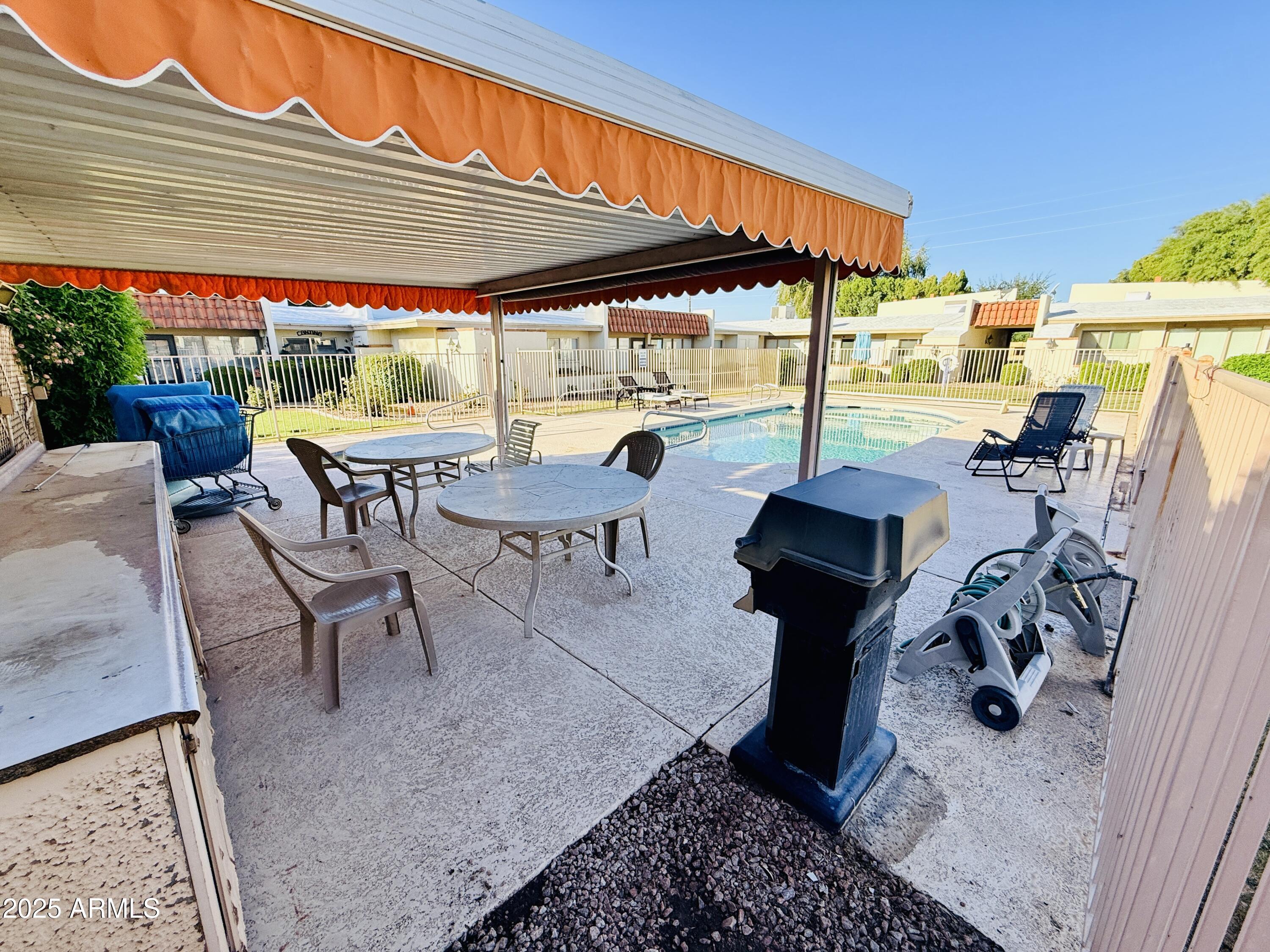 625 South Power Road, Unit 350 Mesa, AZ 85206 - Photo 19 of 20 a view of a patio with table and chairs under an umbrella