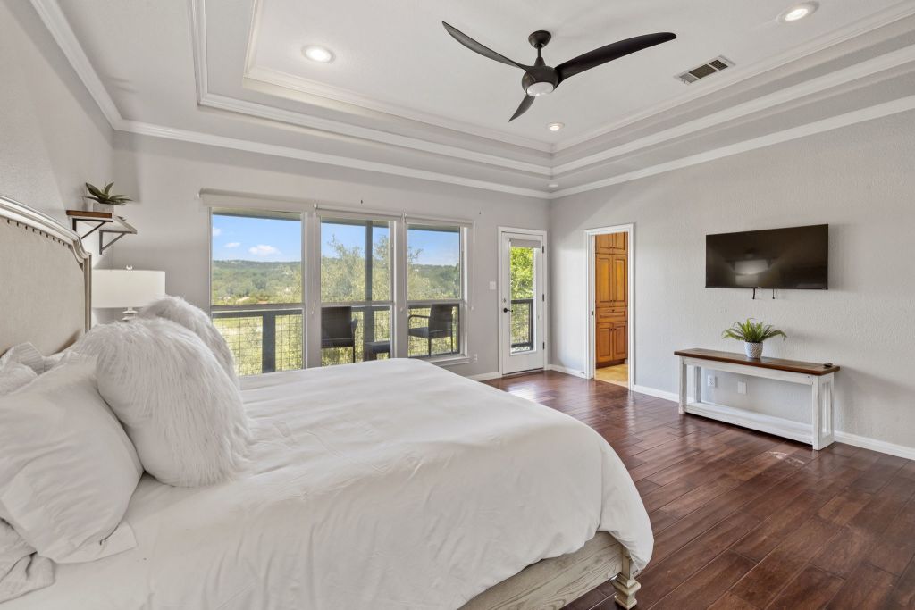 10800 Beach Road Leander, TX 78641 - Photo 16 of 39 Hardwood floors and a tray ceiling create a serene and elegant retreat.