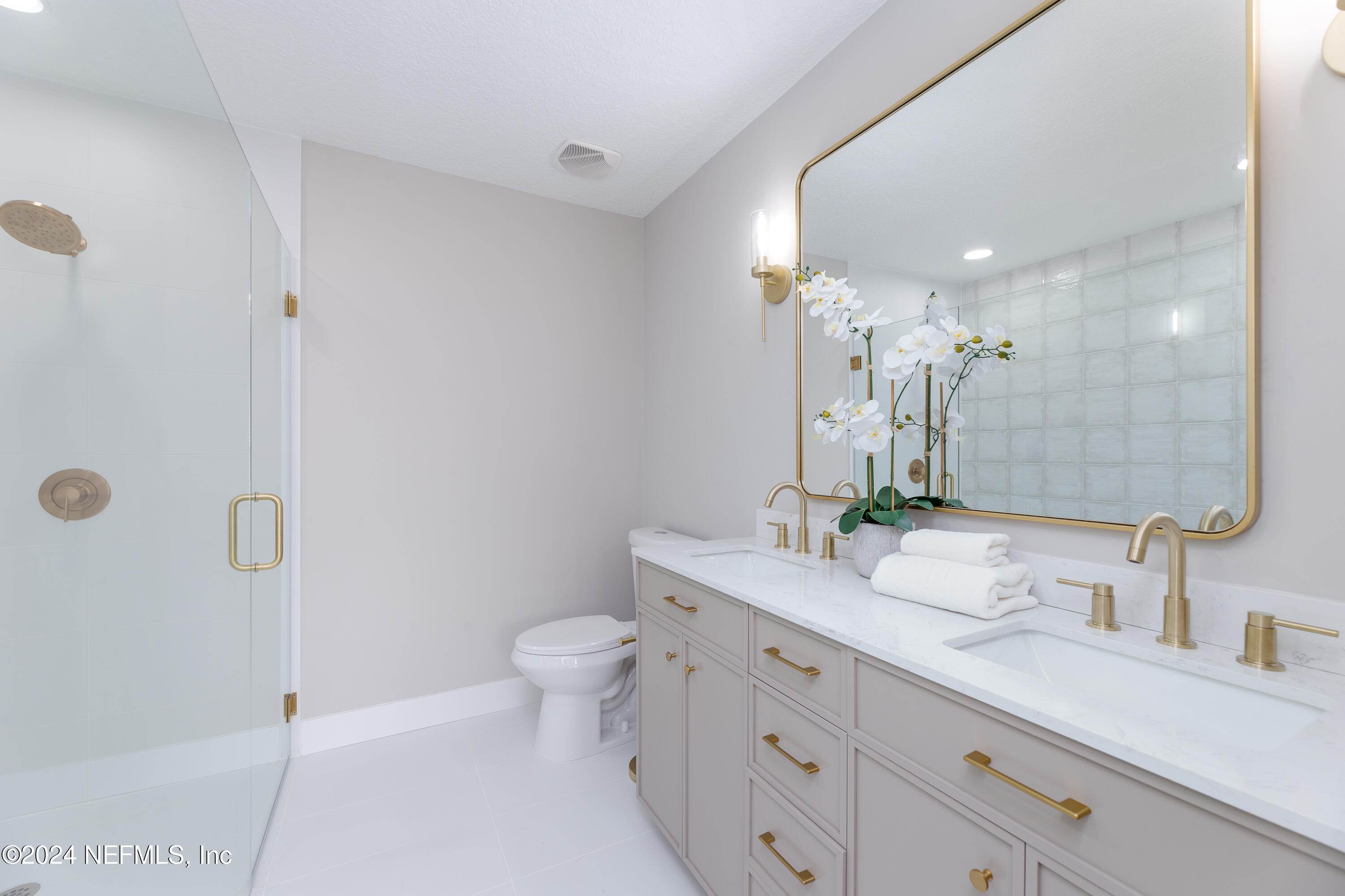 9542 Staples Mill Drive Jacksonville, FL 32244 - Photo 20 of 33 a bathroom with a double vanity sink toilet and shower