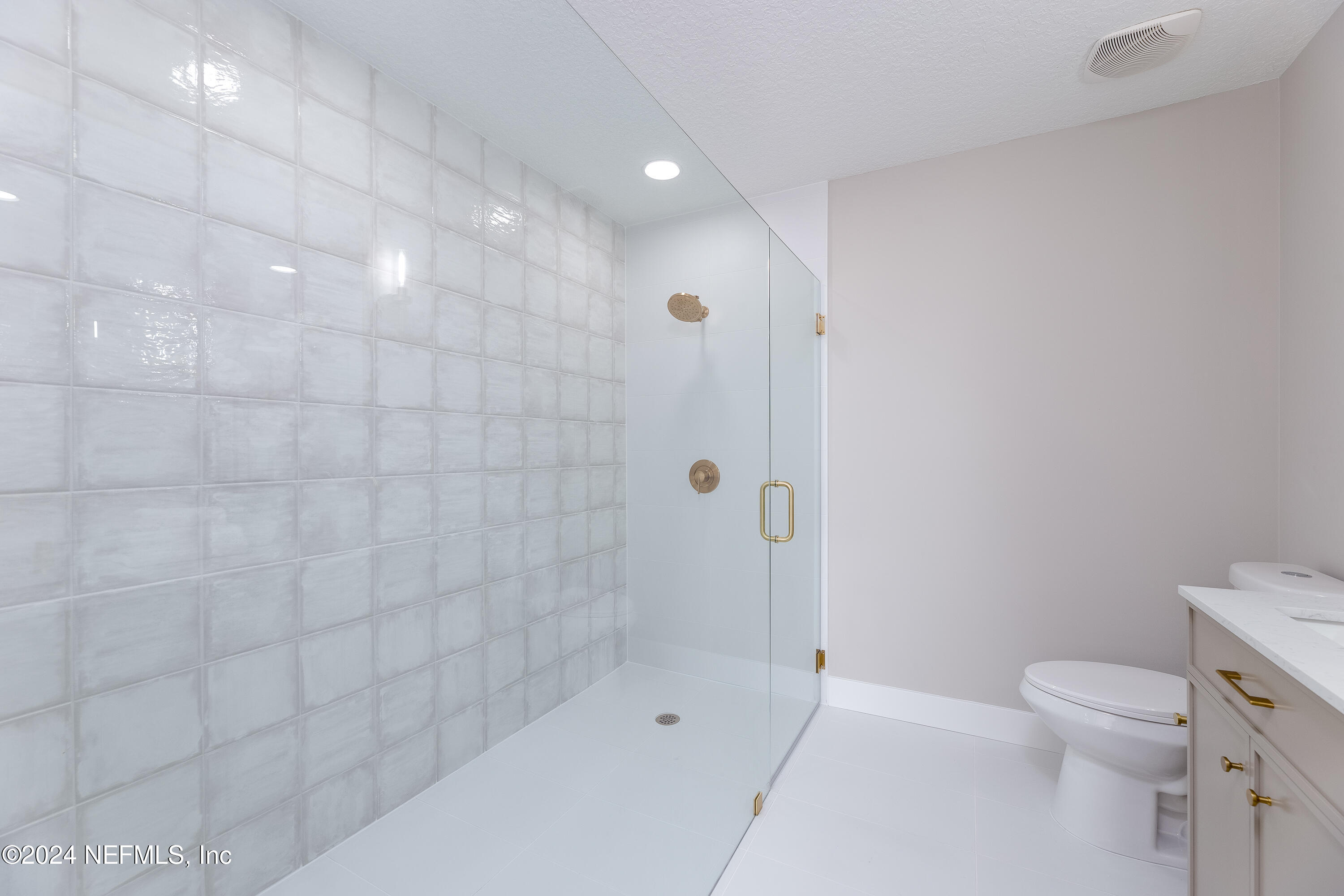 9542 Staples Mill Drive Jacksonville, FL 32244 - Photo 21 of 33 a bathroom with a shower and a toilet