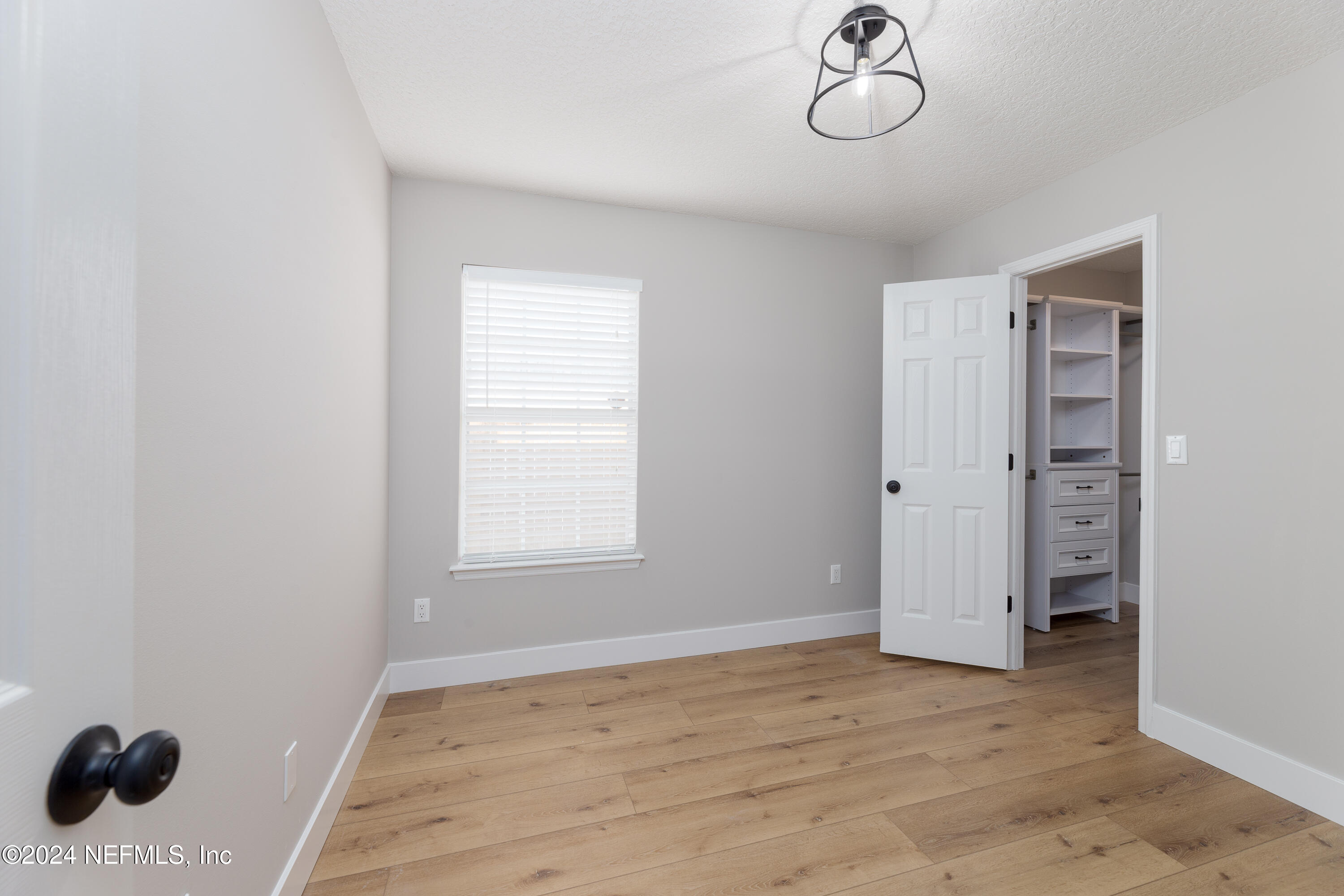 9542 Staples Mill Drive Jacksonville, FL 32244 - Photo 24 of 33 a view of empty room with wooden floor and fan