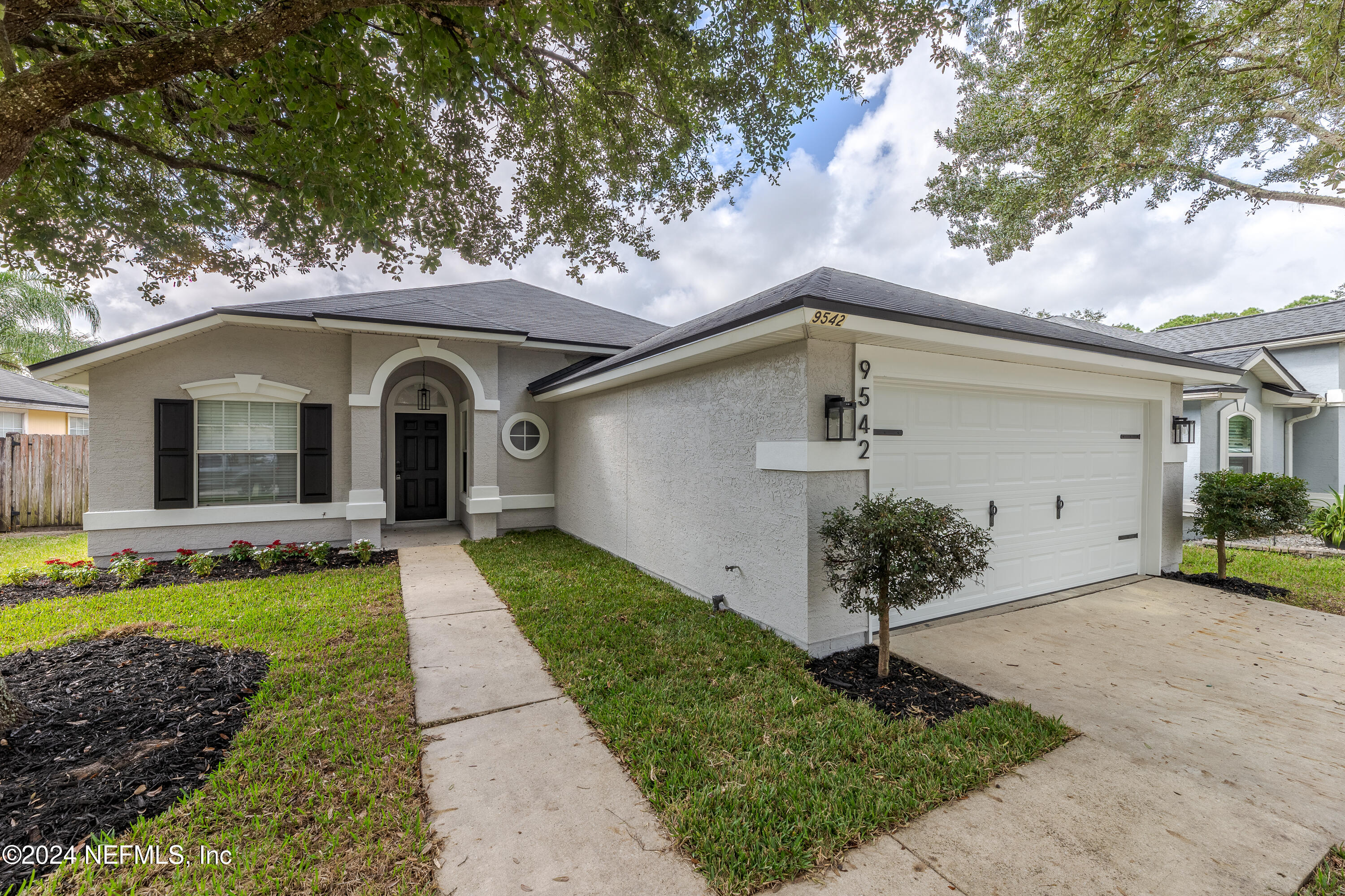 9542 Staples Mill Drive Jacksonville, FL 32244 - Photo 3 of 33 a front view of a house with garden