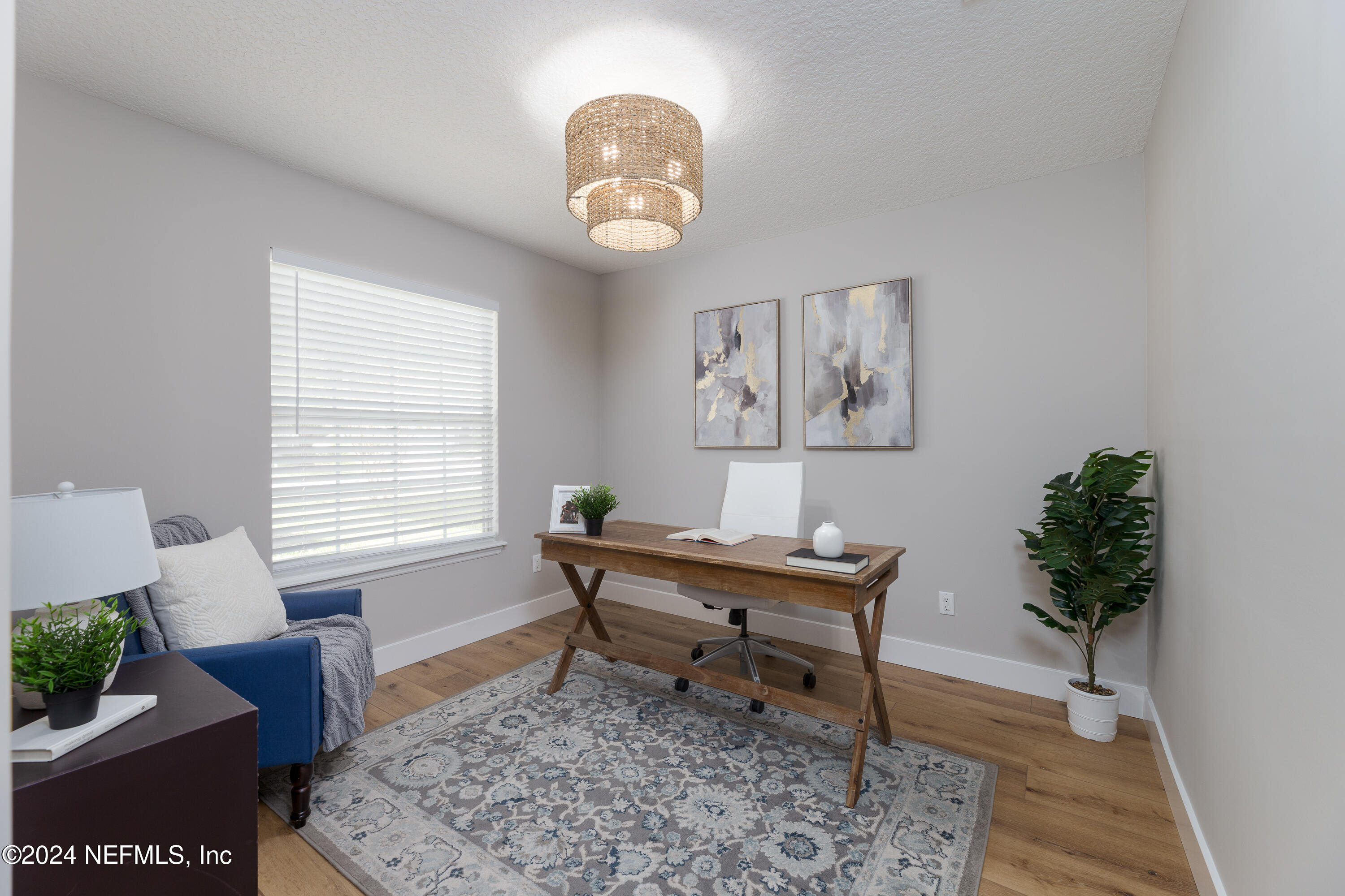 9542 Staples Mill Drive Jacksonville, FL 32244 - Photo 7 of 33 a view of a work space with furniture and a potted plant