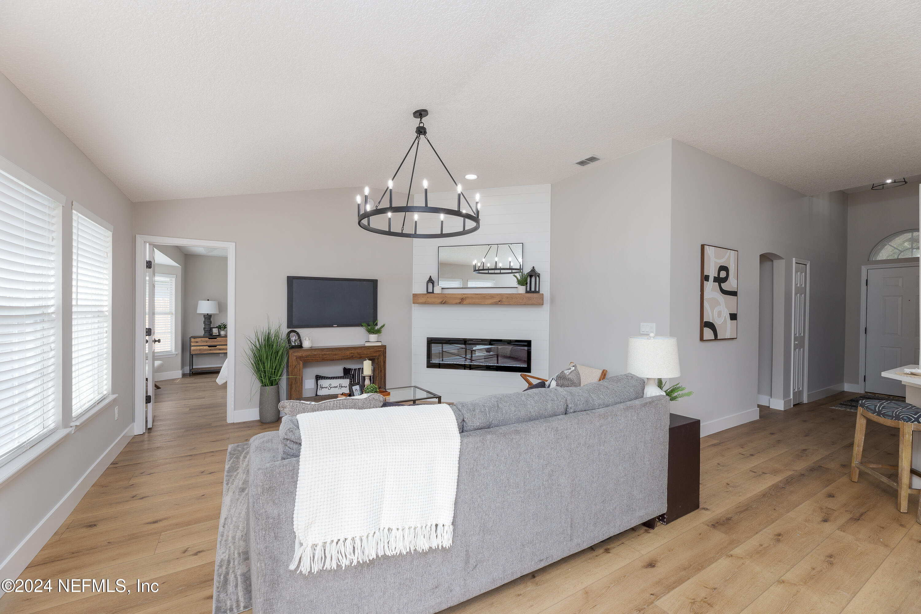9542 Staples Mill Drive Jacksonville, FL 32244 - Photo 8 of 33 a living room with fireplace furniture and a flat screen tv
