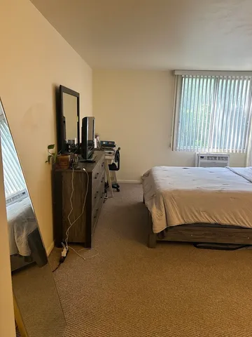 a bedroom with a bed and a television