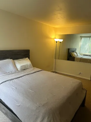 a bedroom with a bed and a night stand