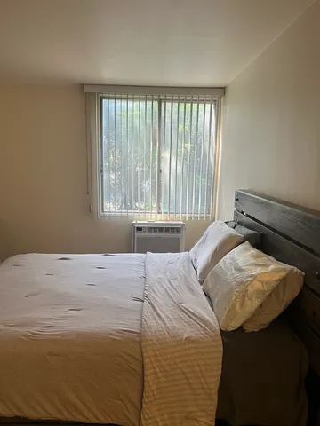 a bedroom with a bed and a window