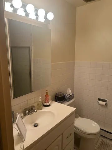 a bathroom with a sink toilet and mirror