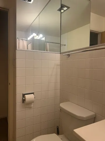 a bathroom with a toilet a sink and shower