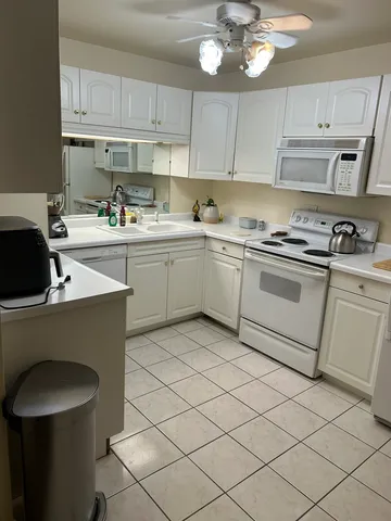 a kitchen with a sink cabinets and window