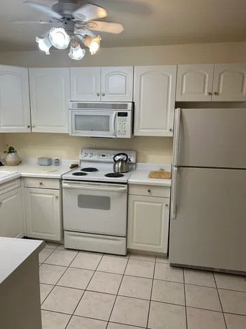 a kitchen with appliances cabinets and a sink