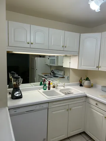 a kitchen with a sink cabinets and appliances