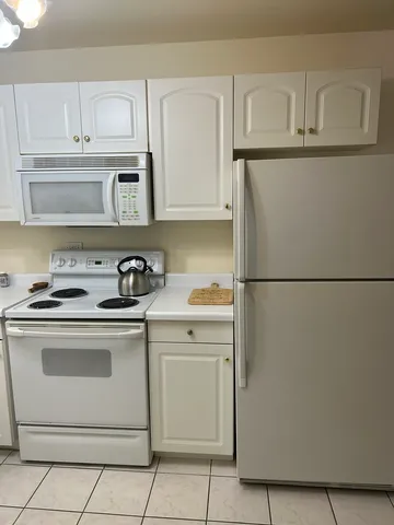 a kitchen with granite countertop cabinets and appliances