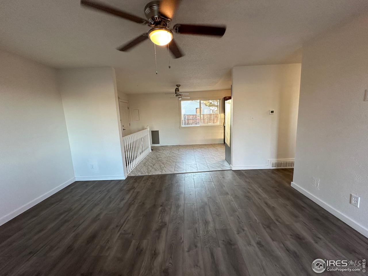 3209 5th Road Greeley, CO 80634 - Photo 9 of 37 an empty room with wooden floor and windows