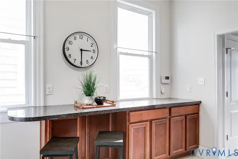 a dining table with a window and wooden floor