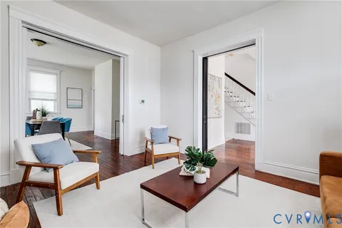 a living room with furniture and a potted plant