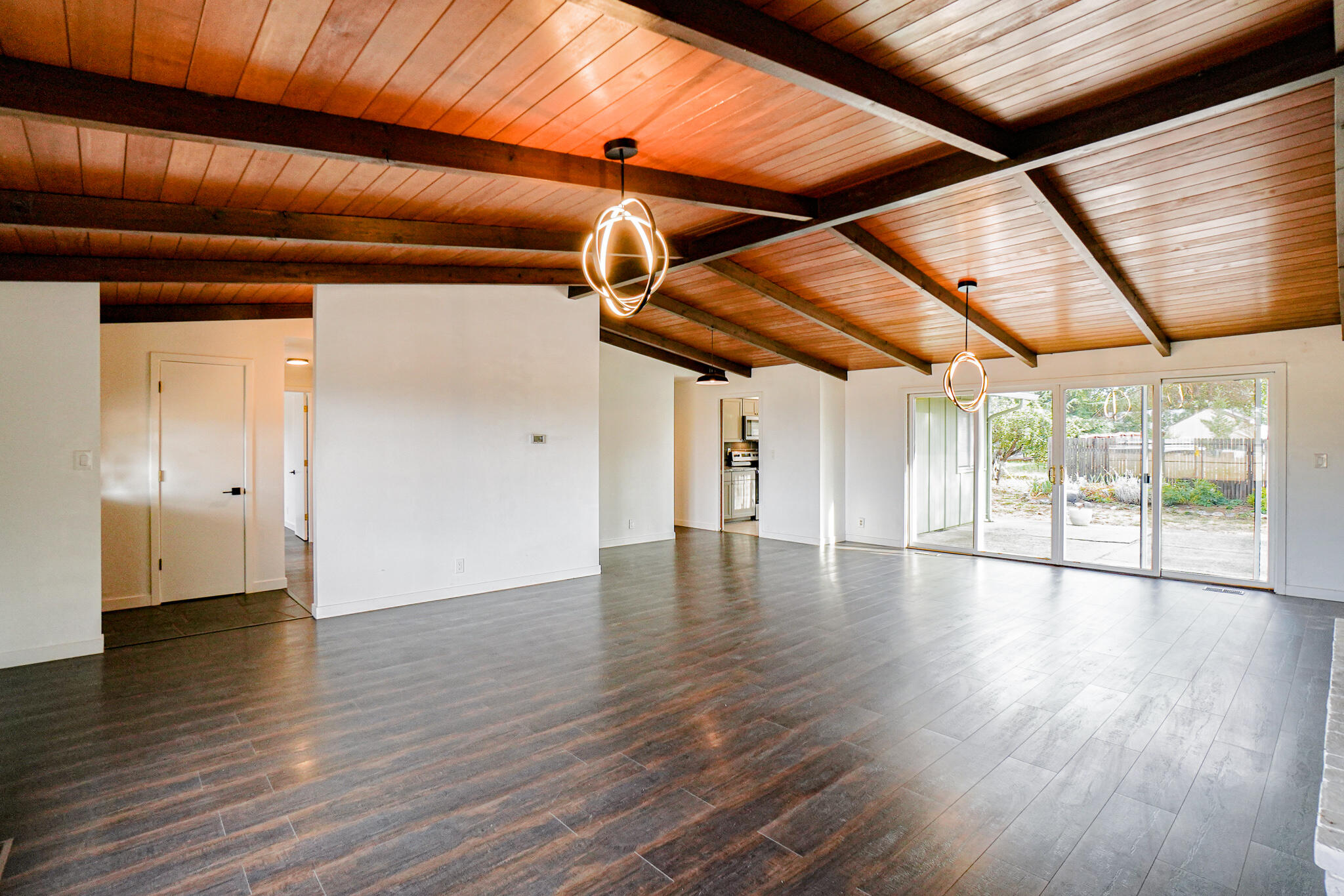 674 Oak Grove Road Medford, OR 97501 - Photo 7 of 47 Living room with hardwood floors, wood-beam vaulted ceiling and brick fireplace.