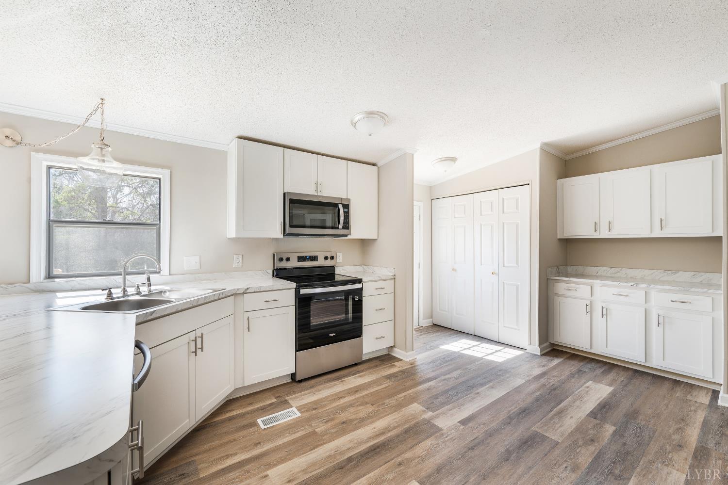 111 Bandy Road Gladys, VA 24554 - Photo 16 of 54 a kitchen with granite countertop a sink stainless steel appliances and white cabinets