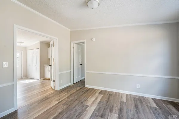a view of empty room with wooden floor